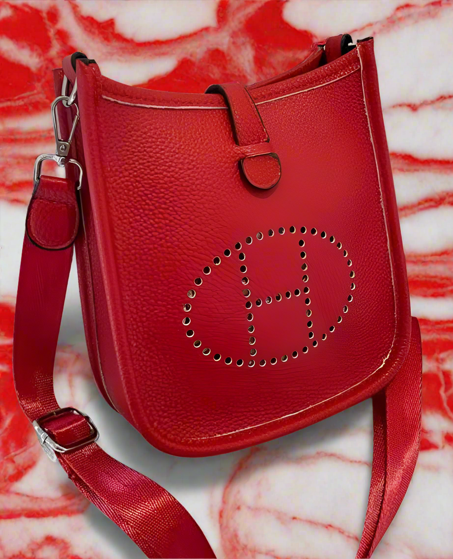 Leather crossbody with hole poke H logo.