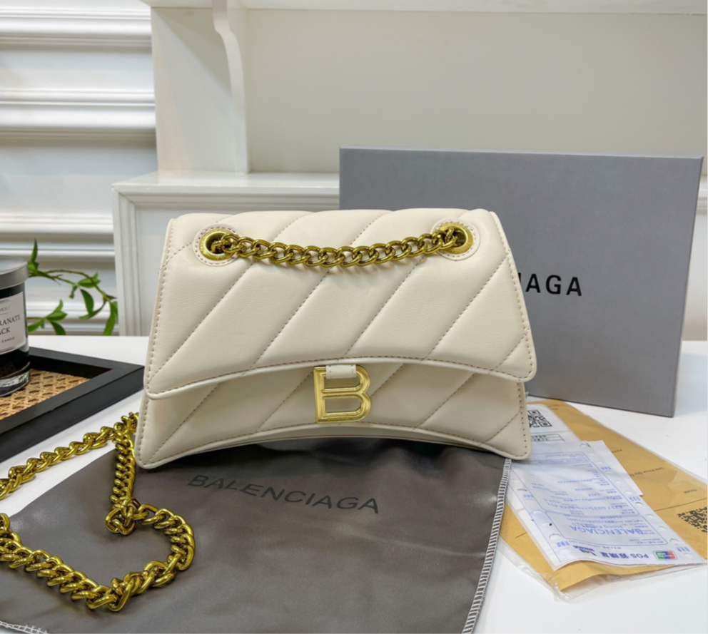 Solid white leather hourglass handbag with diagonal lines design, gold B logo, and gold hardware & chain.