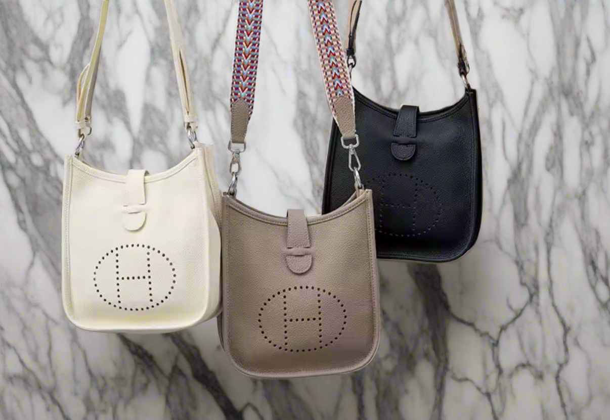 Leather crossbody with hole poke H logo.