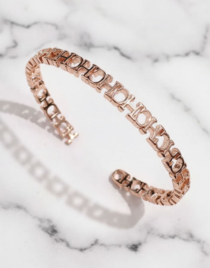Rose gold bracelet on a light gray background