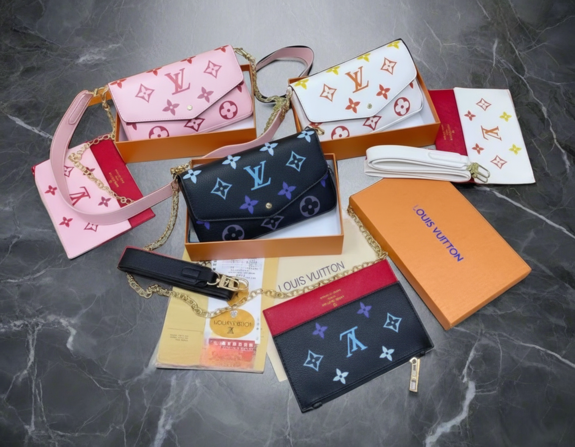 Collection of Louis Vuitton wallets and pouches on a dark marble surface