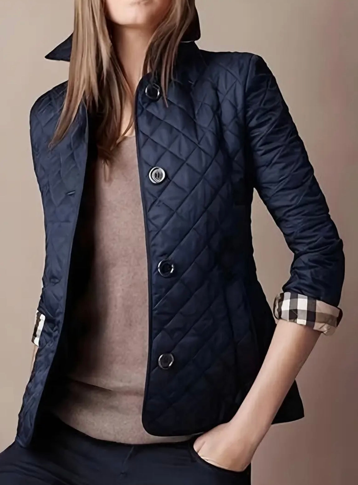 Navy blue quilted jacket with plaid pattern inside lining and collar.  