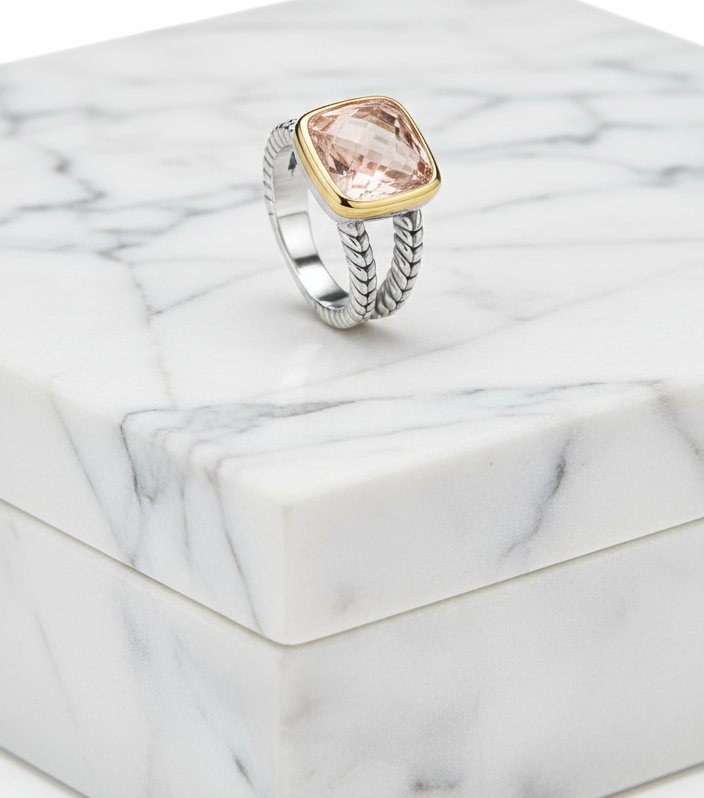 Silver ring with a large pink gemstone and gold accents on a product image screen.