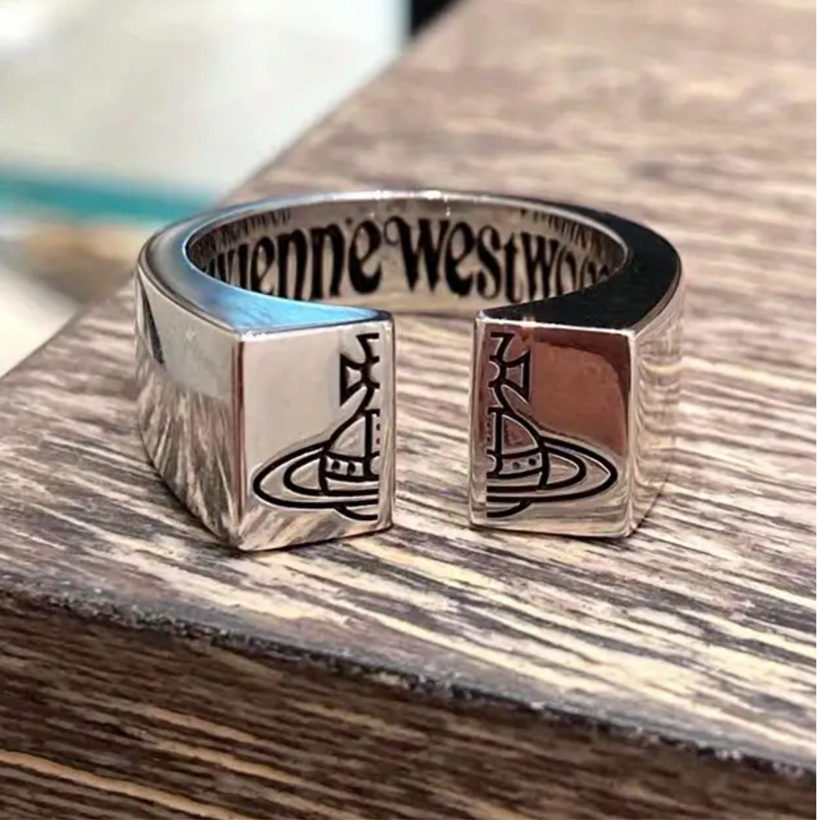 Silver open front Vivienne Westwood ring with Saturn logo on the front. High quality, adjustable, available in 2 colors.  