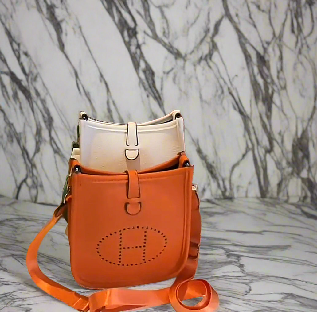 Leather crossbody with hole poke H logo.