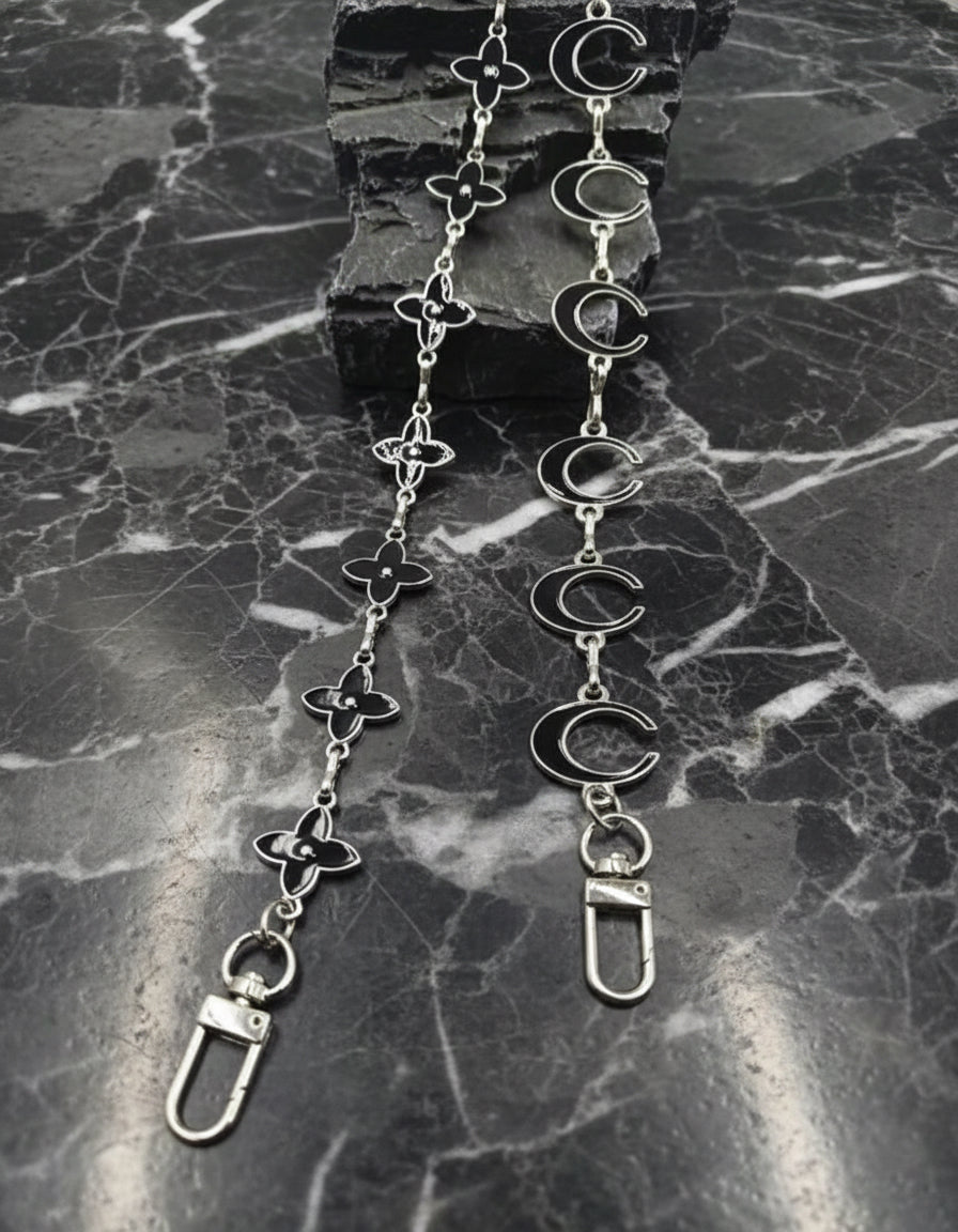 Long bag chains in silver of the moon and star.  (Aka.  The Coach C and LV flower designs).  These are silver colored metal. 