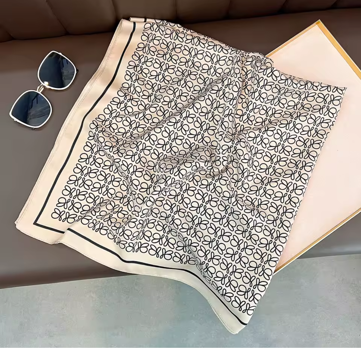 Thin, Light weight, Creme colored scarf w/ little black  L design.  