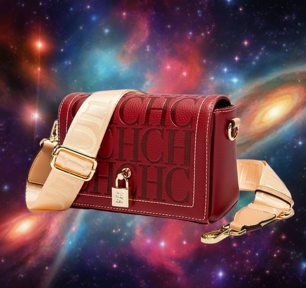 Red handbag with beige strap on a cosmic background