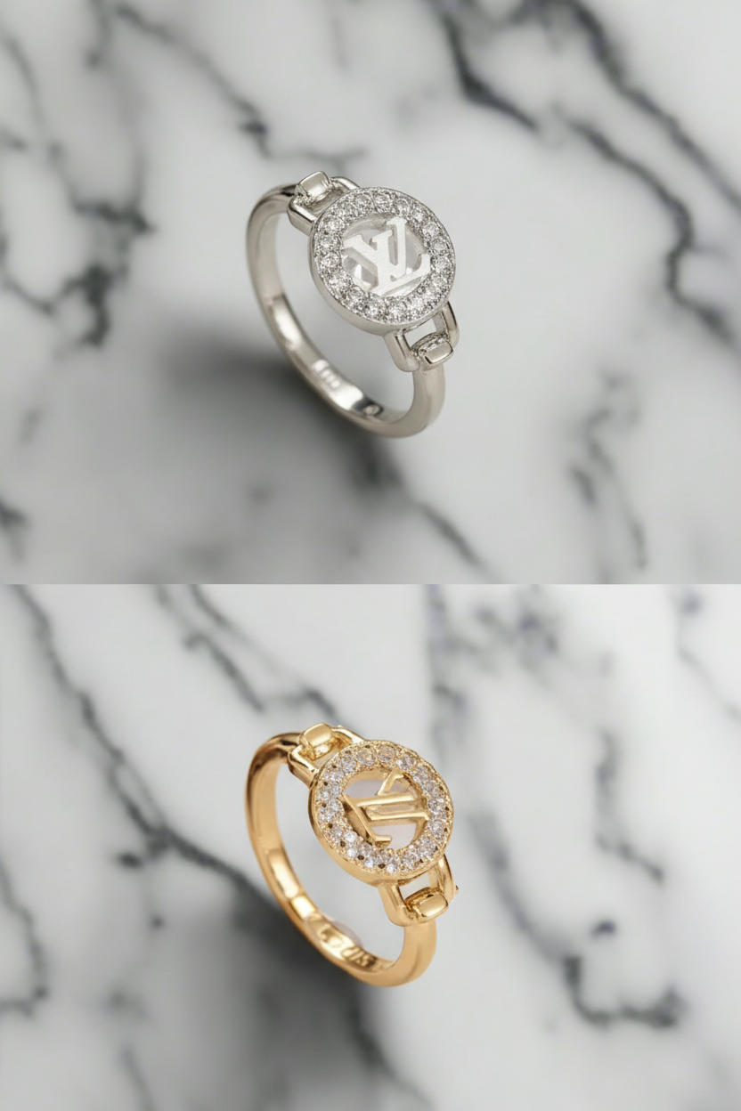 Two LV logo rings, one option is silver and the other is gold, both are high quality and have the name engraved inside.  on a white marble background