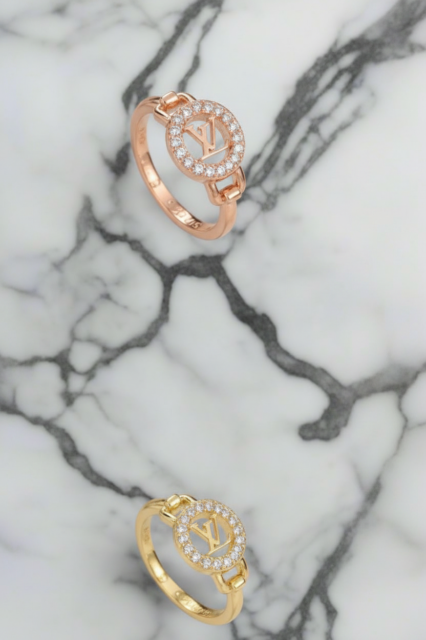 Two LV rings with cubic zirconia crystals in a circle around the center icon.  Gold & silver available 