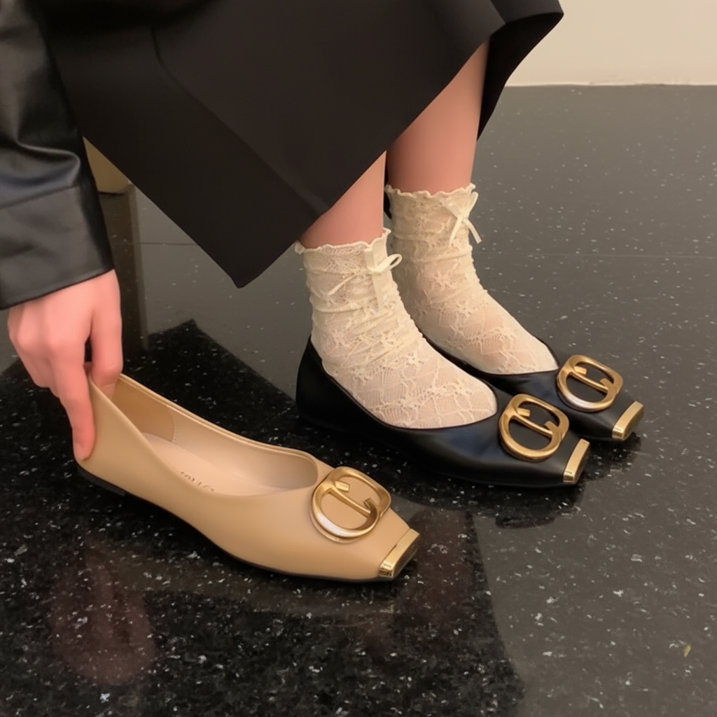 Black and gold shoes with buckles worn by a person on a neutral background