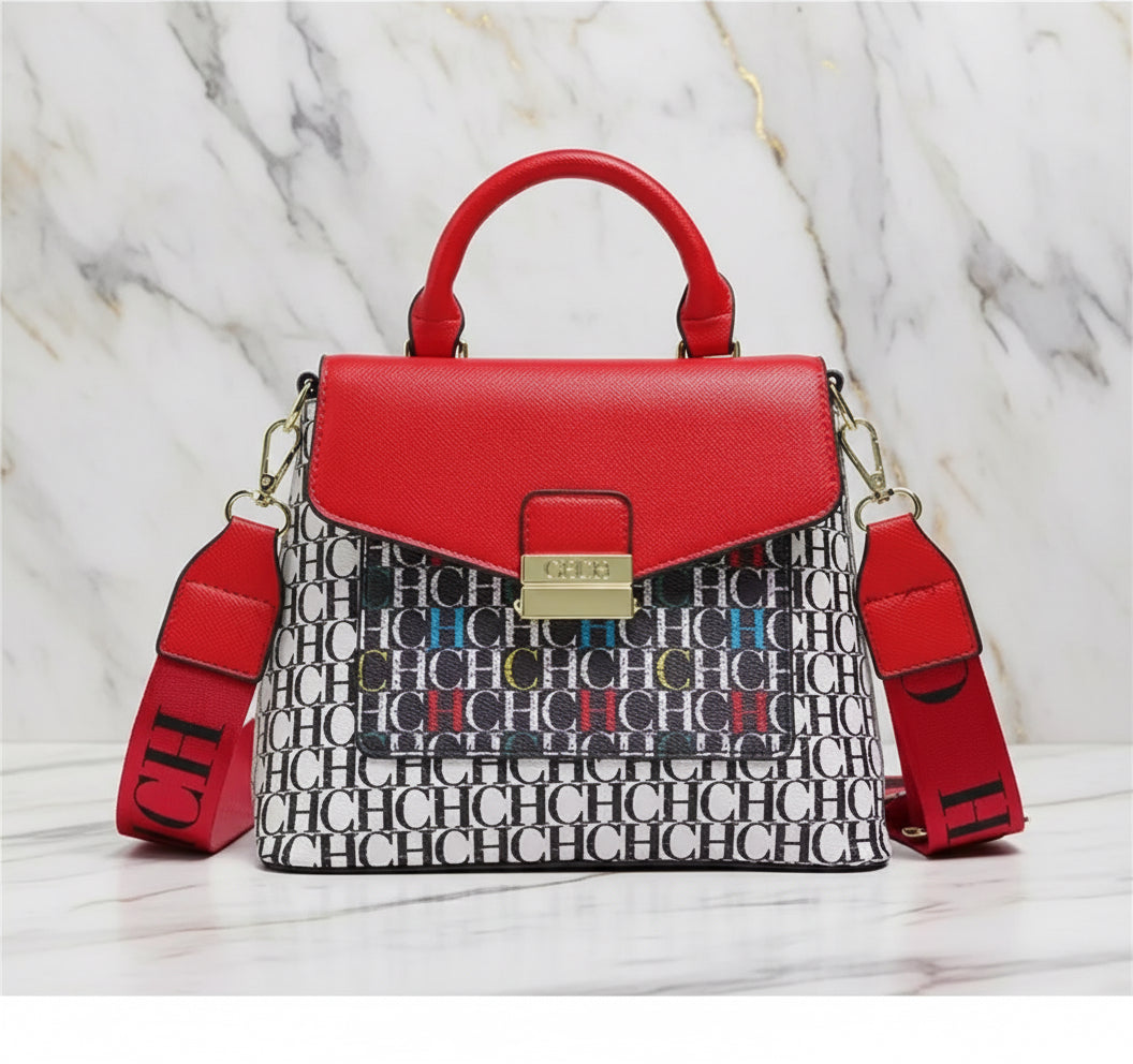 Red handbag with a patterned strap on a white background