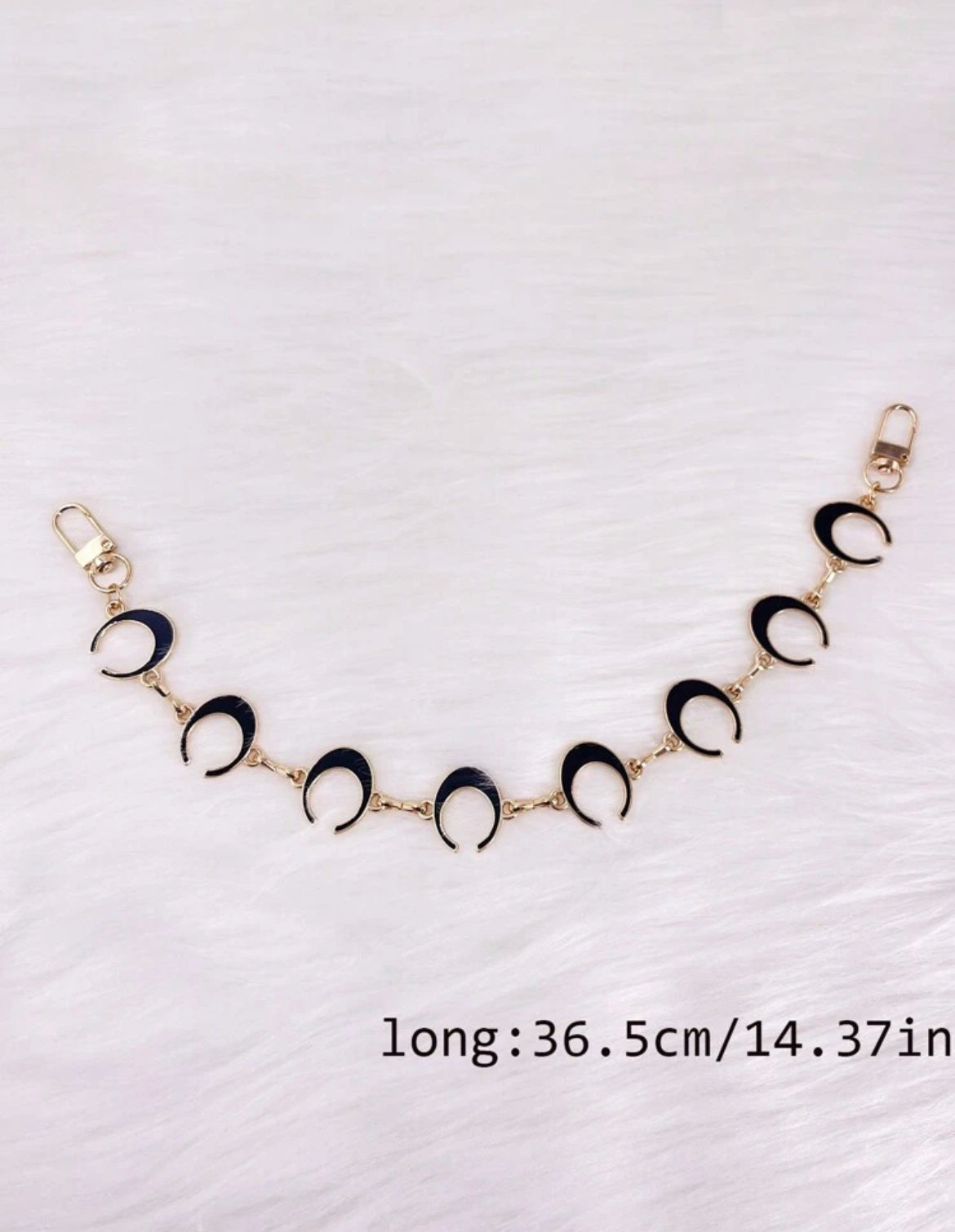 The gold long MOON chain.  These are reversible with black and white enamel on either side. 