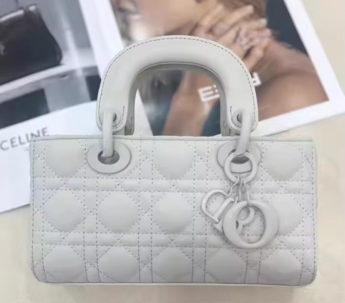 Matte light grey rectangular quilted bag. 