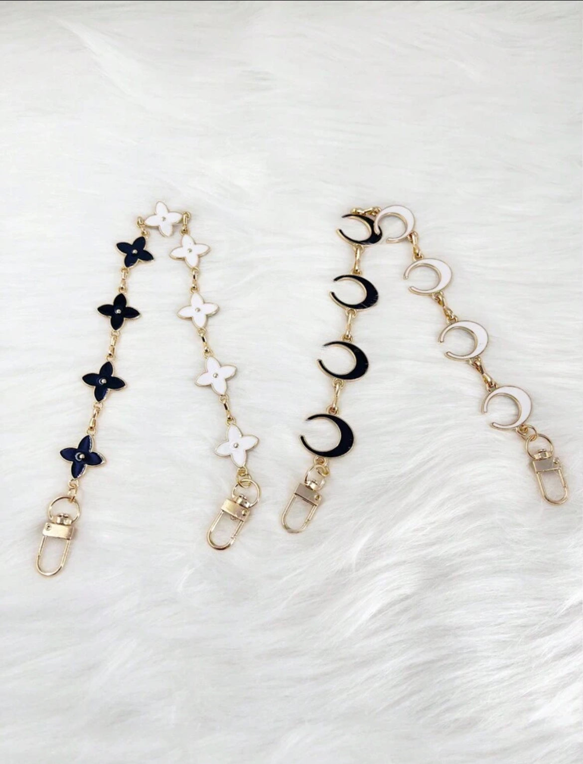 The gold long STAR chain and MOON chain.  These are reversible with black and white enamel on either side. 
